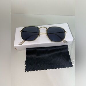 Gold rimmed sunglasses with black lenses